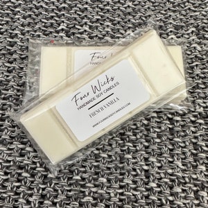 May include: A white wax melt with a label that reads "Four Wicks Handmade Soy Candles French Vanilla" and a website address. The wax melt is packaged in clear plastic.