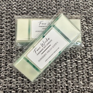 May include: Two wax melts in clear packaging with a white label that reads "Four Wicks Handmade Soy Candles Peppermint and Eucalyptus www.fourwickssoycandles.com"