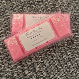 May include: Pink soy wax melt with glitter in a clear plastic packaging. The wax melt is labelled "Four Wicks Handmade Soy Candles" and "Life is Sweet". The website address is printed on the label: www.fourwickssoycandles.com