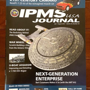 May include: A magazine cover featuring a model of the USS Enterprise from Star Trek: The Next Generation. The cover also features a 21st Century Camaro muscle car and the text "IPMS USA Journal".