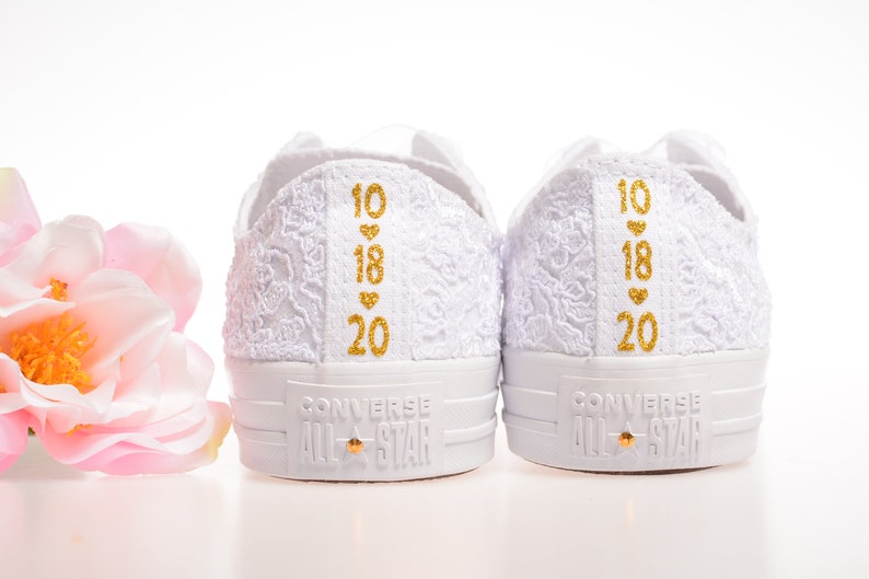 Indulge in luxury with Ivory Wedding Converse Lace Low Top. Custom Converse shoes for the bride, personalized with Dubai lace. Perfect for a stylish and comfortable bridal ensemble