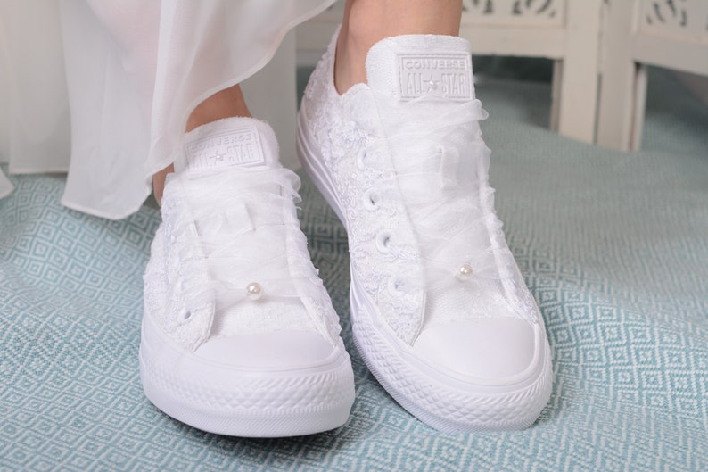 Elegant and chic, these personalized low top tennis shoes feature exquisite Dubai lace detailing. Luxury White Wedding Converse for the stylish bride. Perfect for adding a touch of sophistication to your bridal ensemble. Lace Converse Bridal