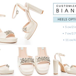 May include: Ivory platform sandals with ankle straps and block heels. Each sandal features a decorative rhinestone embellishment on the toe strap. The image includes text that reads "CUSTOMIZATION BIANKA" and "HEELS OPTIONS: 5 cm/2 in, 7 cm/2.75 in, 11 cm/4.3 in."
