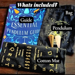May include: An essential pendulum guide, a black bag, a cotton mat, and two pendulums are displayed. The guide is blue with gold accents. The cotton mat has numbers and letters. The bag is black with a sun and moon design.