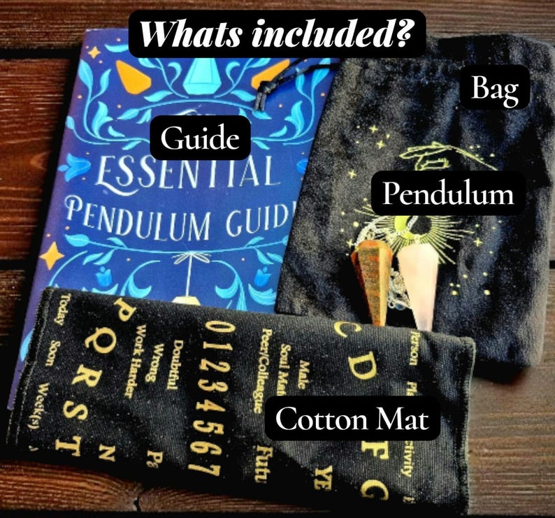 May include: An essential pendulum guide, a black bag, a cotton mat, and two pendulums are displayed. The guide is blue with gold accents. The cotton mat has numbers and letters. The bag is black with a sun and moon design.