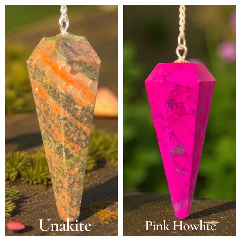 May include: Two gemstone pendulums suspended by silver chains. One is Unakite, with green, orange, and brown patterns. The other is Pink Howlite, a vibrant magenta color. The pendulums are faceted and cone-shaped.