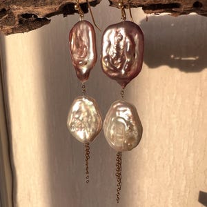 stunning white and creamy purple keshi pearl earrings, with dainty dangling gold chain