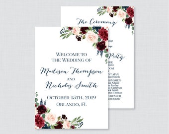 May include: Wedding announcement card with a floral design in shades of burgundy, blush pink, and navy blue. The text reads "Welcome to the Wedding of Madison Thompson and Nicholas Smith, October 15th, 2019, Orlando, FL."