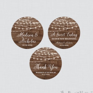 May include: Three round rustic wood wedding favor stickers with string lights. The first sticker says "Madison & Nicholas 10-15-2025". The second sticker says "A Sweet Ending To Our New Beginning Madison & Nicholas 10-15-2025". The third sticker says "Thank You MADISON & NICHOLAS 10-15-2025".