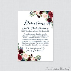 May include: A white card with a floral design in shades of burgundy, pink, and blue. The card has the text "Directions" in a navy blue cursive font. The text "South Park Gardens" is in a navy blue font. The address is "7273 Westhaven Street | Orlando, FL". The text below the address provides directions to the location. The text "We look forward to seeing you there!" is in a navy blue cursive font. The text "The Papered Wedding" is in a navy blue font.