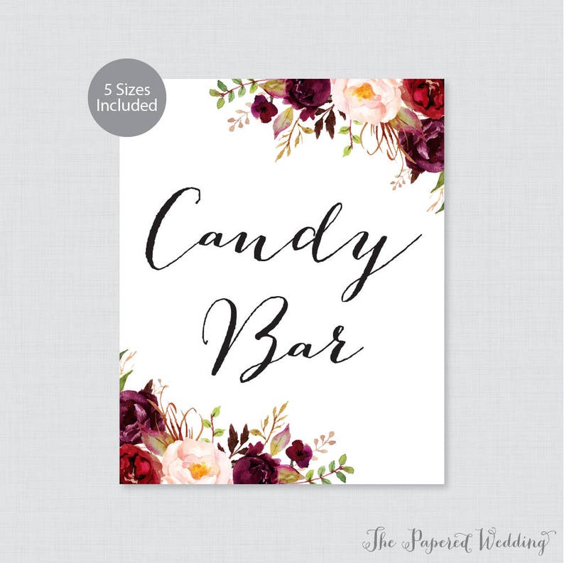 May include: A white sign with the text "Candy Bar" in black calligraphy. The sign is decorated with burgundy and pink floral illustrations.