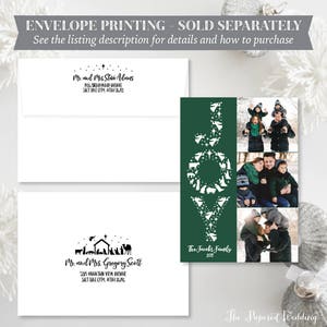 May include: A holiday card with a green background and the word "JOY" in white, filled with nativity scene silhouettes. Includes family photos and two white envelopes with printed addresses. The text reads "The Jacobs Family 2017."