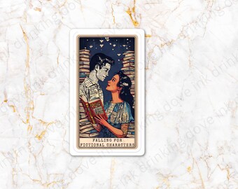 May include: A vintage-style tarot card with a blue background and a couple made of books. The man is made of a stack of books and the woman is made of a stack of books. The card reads "Falling for Fictional Characters".