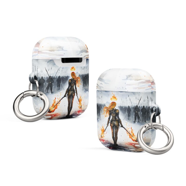 May include: A white Airpods case with a colorful design featuring a woman with a crown of fire walking towards a line of soldiers. The case has a silver metal keychain attached.