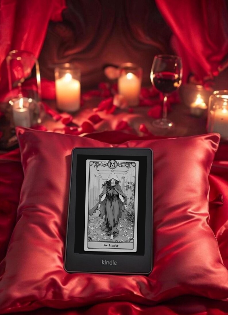 May include: A black and white tarot card image of The Healer on a Kindle e-reader. The card is displayed on a red satin pillow with candles and a glass of wine in the background.