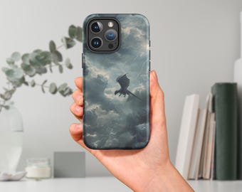 May include: A black phone case with a dark gray and blue cloudy sky design featuring a black dragon flying through the clouds.
