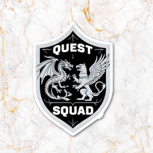 May include: Black and white sticker featuring a shield design. The shield depicts a dragon and a griffin facing each other. The text "QUEST SQUAD" is written in white letters on a black background.