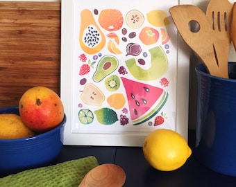 May include: A framed print of a watercolor illustration featuring a variety of fruits and vegetables, including watermelon, papaya, avocado, kiwi, mango, lemon, and berries. The print is set against a white background and is framed in a white frame.