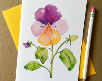 May include: A watercolor painting of a single purple, yellow, and white pansy flower with green leaves and a bud.