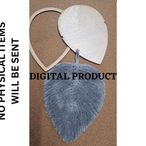 以下が含まれることがあります： DIYクラフトプロジェクト用のグレーの羽根の形をしたデザインのデジタルダウンロード。デザインは、ハート型の木製カットアウトに表示されています。画像には「デジタル製品」というテキストが表示されています。