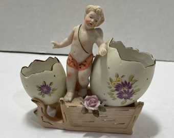 Cherub decorated egg shells applied flower on sled 6516