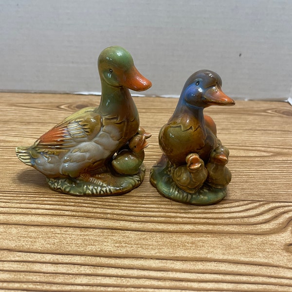 Pair of duck figurines with their baby duck.