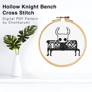 May include: A cross-stitch pattern of a Hollow Knight character sitting on a bench, framed in a wooden embroidery hoop. The text "Hollow Knight Bench Cross Stitch" and "Digital PDF Pattern by Chonkarumi" are displayed above the hoop.