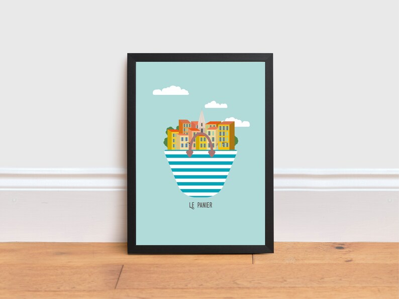 May include: A framed print of a colorful illustration of a city skyline inside a striped beach bag. The city is called "Le Panier" and is set against a light blue sky with white clouds.