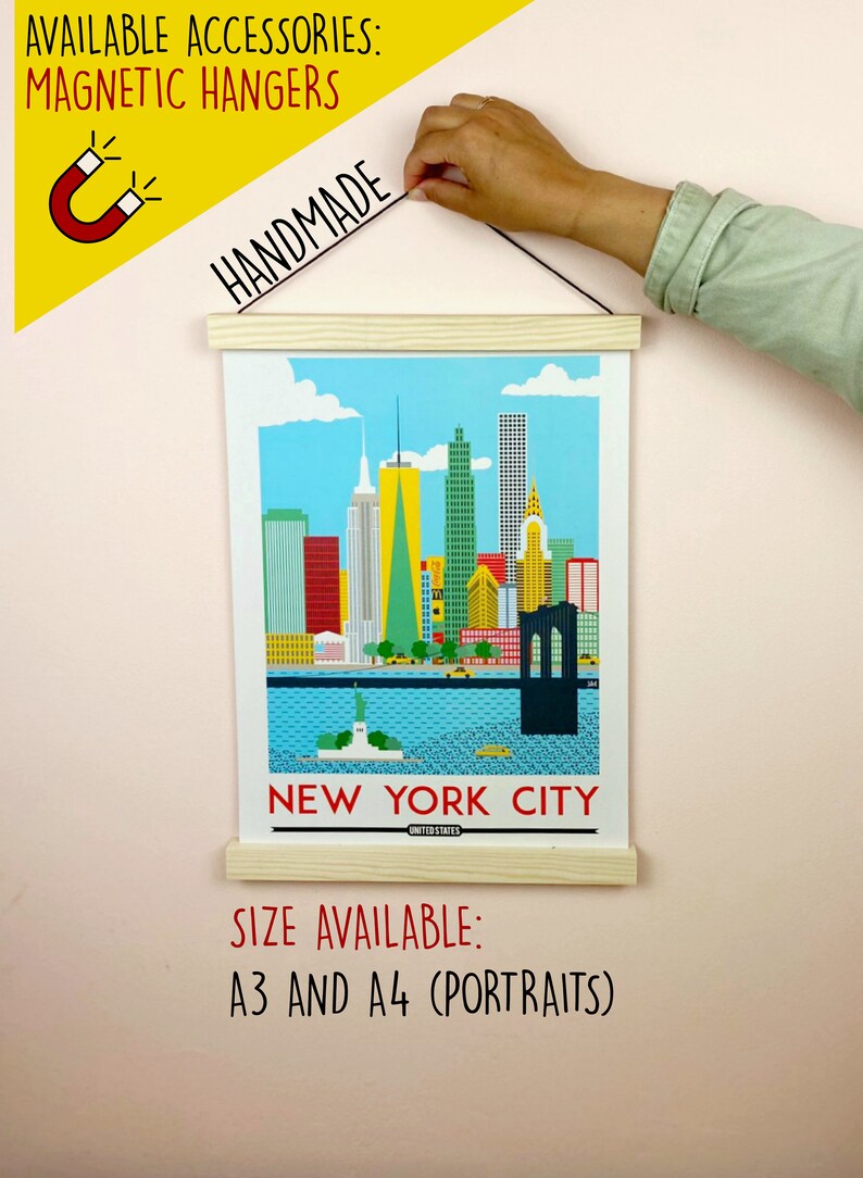 May include: A colorful illustration of the New York City skyline with the Statue of Liberty in the foreground. The print is framed with a wooden hanger and is available in A3 and A4 sizes. The text "NEW YORK CITY" and "UNITED STATES" is printed below the image.