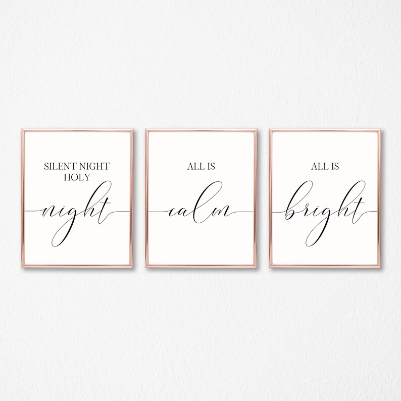 May include: Three framed prints with rose gold borders. The prints feature elegant black script on a cream background. The text on the prints reads "SILENT NIGHT HOLY night", "ALL IS calm", and "ALL IS bright".