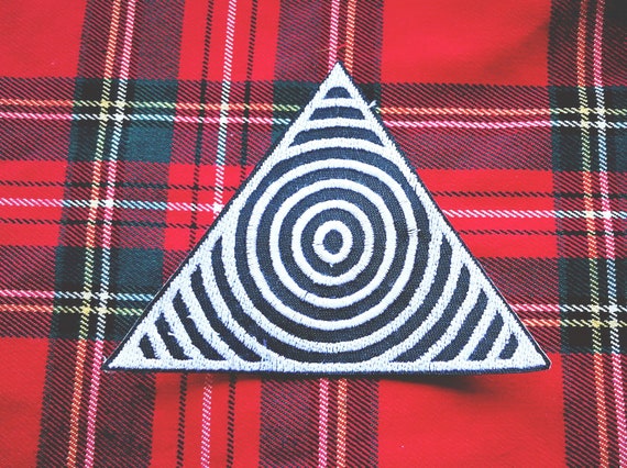 Embroidered triangle patch with concentric circles. Approximate size 9 cm
