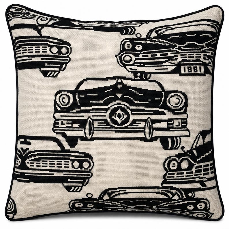 May include: A square throw pillow featuring a repeating black and white graphic pattern of vintage automobiles. The design includes various car front-end views with detailed grilles and headlights, finished with a solid black piped edge trim.
