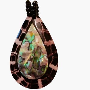 May include: A teardrop-shaped pendant with a black and brown patterned border. The center features iridescent abalone shell with green, blue, and gold hues. The pendant is topped with a string of small black beads, creating a unique jewelry piece.
