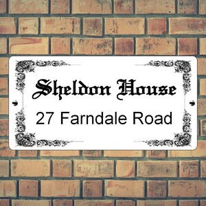 May include: White rectangular sign with black ornate borders and text. The sign reads "Sheldon House" and "27 Farndale Road".