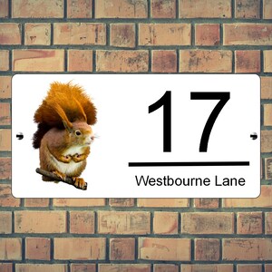 May include: White house number sign with a red squirrel illustration, the number 17 and the text "Westbourne Lane".