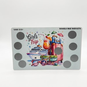 May include: A light blue card with a colorful illustration of a cruise ship, luggage, and a cocktail, with the words "Girls' Trip" and "Sharla Mae Budgets". The card has several scratch-off circles.