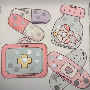 May include: A collection of budget-themed stickers in the shape of pills, a medicine bottle, a first aid kit, and a bandage. Each sticker has a "SAVE" amount and the text "SHARLA MAE BUDGETS". The stickers are in shades of pink, purple, and gray.