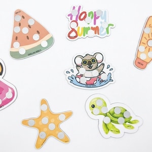 May include: A collection of summer-themed stickers featuring a watermelon slice, a flamingo, a starfish, a turtle, a koala in a pool float, a tube of sunscreen, and the words "Happy Summer". Each sticker has a series of silver dots.