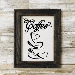May include: A black and white sign with the word "Coffee" in a decorative font. The sign also features a stylized image of a coffee cup with steam rising from it in the shape of hearts.