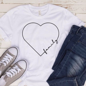 May include: White t-shirt with a black outline of a heart and the word "family" written inside the heart.