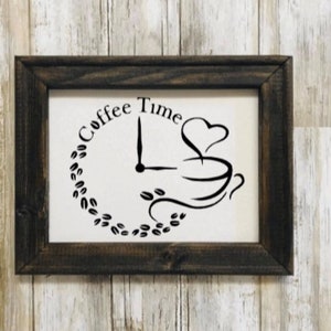 May include: A framed black and white sign with the text "Coffee Time" in a circle with a coffee cup and clock hands inside the circle.