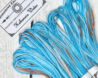 Habanero Water Hand Dyed Embroidery Thread in Shades of Pastel Blue with Fire Orange Speckles