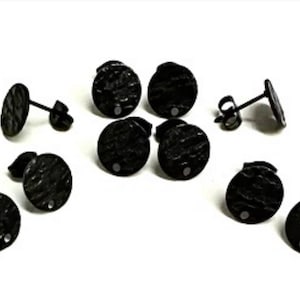 May include: Several pairs of black, textured stud earrings with a hammered metal effect. The earrings are circular with a small post and backing. The image shows multiple pairs, some with the backs visible.