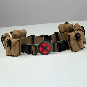 May include: A brown canvas belt with multiple pouches and a black buckle. The belt has a red X on a black circle in the center.