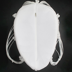 May include: White mesh drawstring bag with a zipper closure. The bag is made of a lightweight, breathable material and has a round shape.