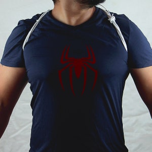 May include: A navy blue t-shirt with a red spider graphic on the front.