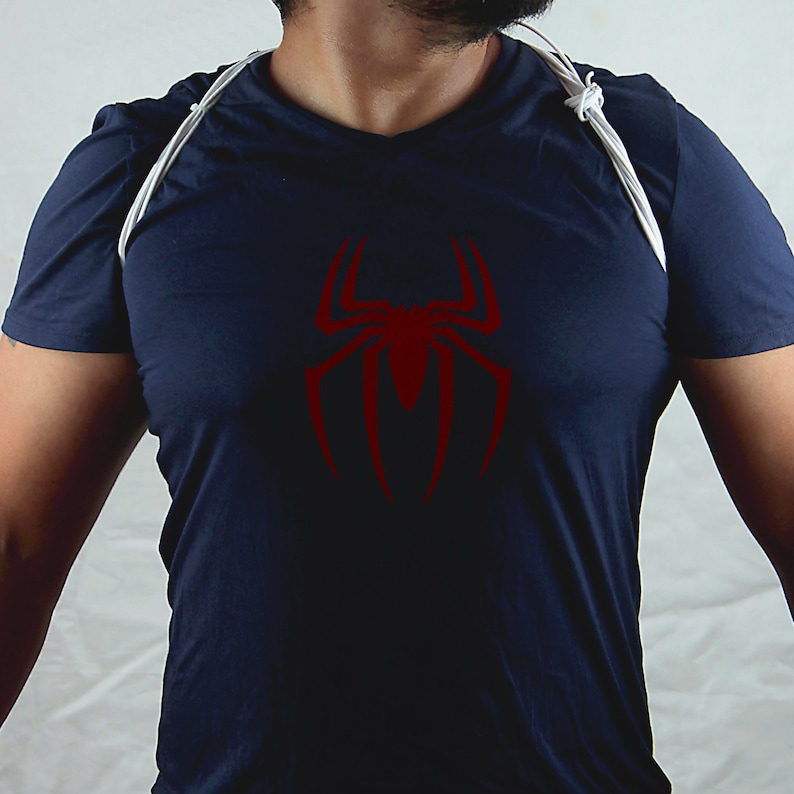 May include: A navy blue t-shirt with a red spider graphic on the front.