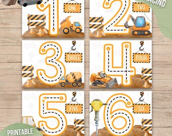 May include: Six printable number tracing cards featuring construction vehicles and tools. Each card has a number 1 through 6 with a dotted line for tracing. The cards are labeled with the number name, such as "One", "Two", etc.