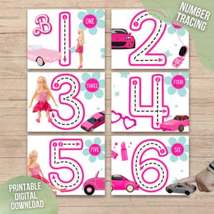 May include: Six printable number tracing cards featuring pink numbers with a pink and white dotted line for tracing. Each card has a different pink themed image, including a doll, a car, a lipstick, and a phone. The text "NUMBER TRACING" is at the top of the cards. The text "PRINTABLE DIGITAL DOWNLOAD" is at the bottom of the cards.