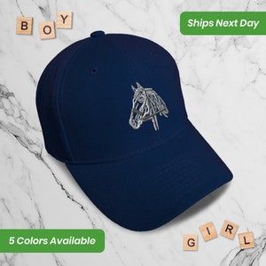 May include: A navy blue baseball cap with an embroidered silver horse head design. The cap has a curved brim and a structured crown.